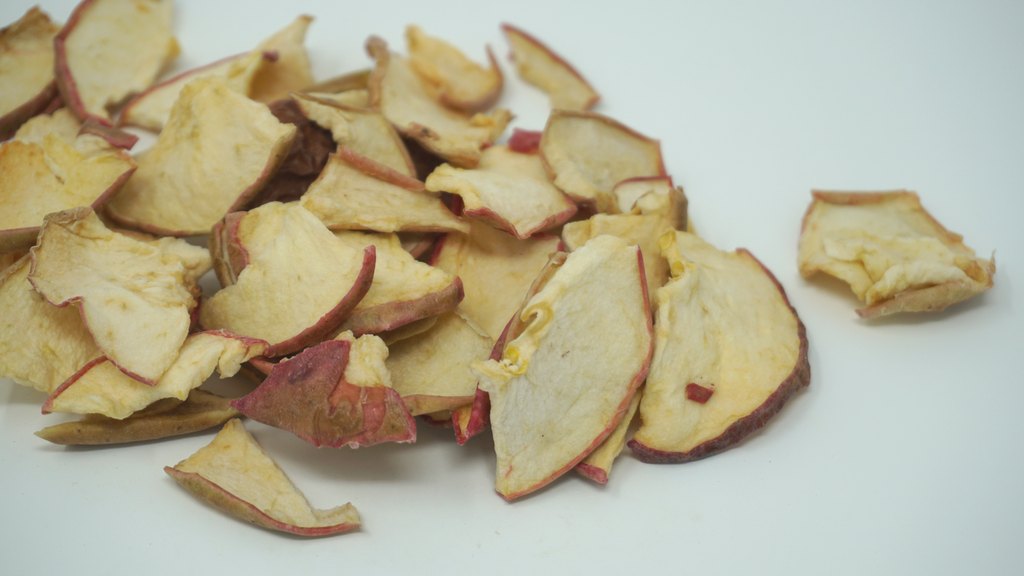 Unsulphured low-moisture apple chips with red peel, side view